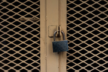 Locked door. Closed padlock on an old metal door