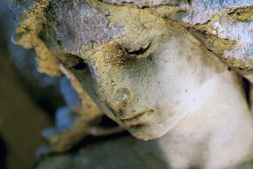 Close up of sad guardian angel. (fragment of an antique statue)