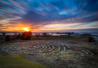 stones laid out in circles on a lawn at sunset