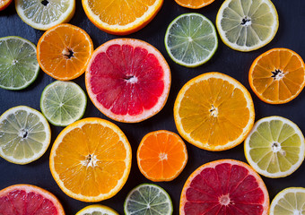citrus fruit slices on dark surface