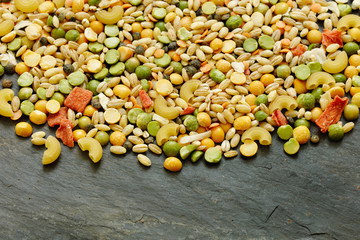 Mixed dried vegetables and pasta for vegan stew or soup with copy space