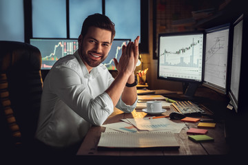 Young male trader at office work concept sitting successful leader