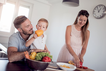 Family preparing meal with son