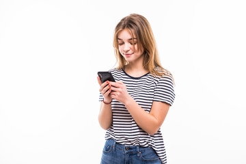 Front view portrait of a young smiling caucasian tenn sending an sms, on white background