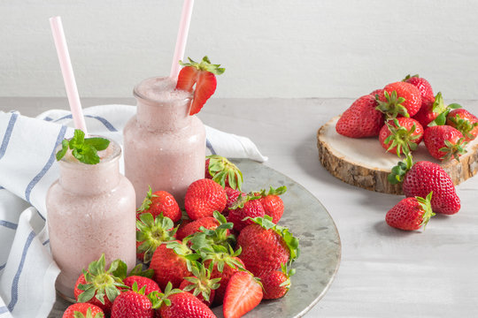 Strawberry milkshake or smoothie in glass jars