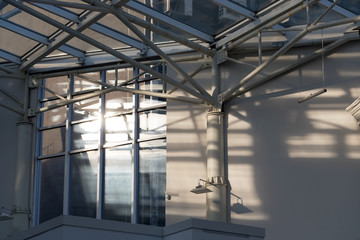 the sun in metal constructions of a glass roof