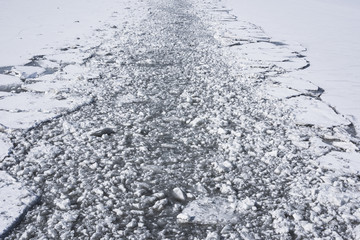 Water with broken ice, the beginning of ship navigation