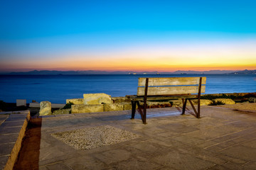 Fototapeta na wymiar Bench view to the sea and sunset