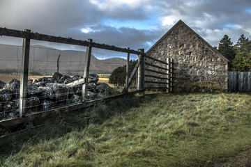 Fototapeta na wymiar Scottish rural landscape. Farm in the mountains. Cairngorms National Park, Ballater, Aberdeenshire, Scotland, UK. Loch Muick area. 