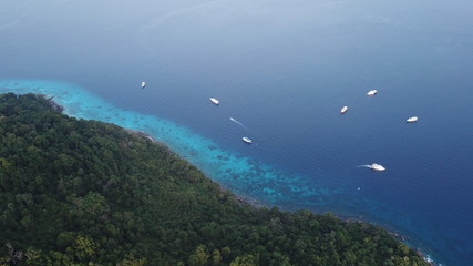 Aerial photo tropical island and ocean with yachts in Thailand