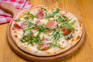 Pizza with Parma ham and arugula