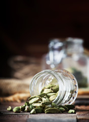 Dry whole cardamom, vintage wooden background, selective focus