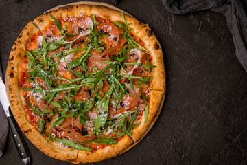 Pizza with Parma ham and arugula