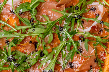 Pizza with Parma ham and arugula