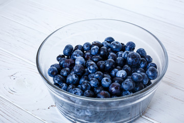 healhty breakfast or meal on white wooden table with cottage cheese and berries