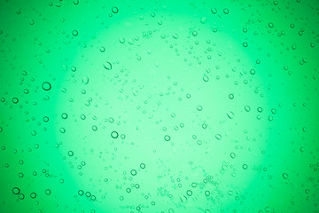 Rain droplets on green glass background, Water drops on glass.