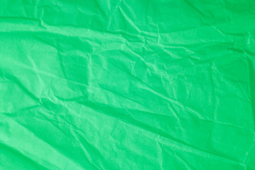 Fototapeta premium Green crumpled paper background.