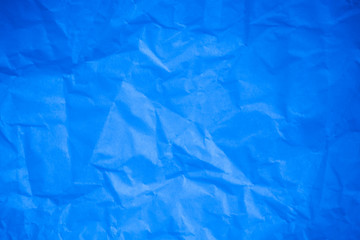 Crumpled blue paper background.