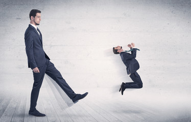 Giant man kicking out small man from space with grungy background

