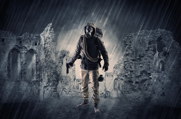 Hazard, menace man in a ruined crumbly building with arms on his hand
