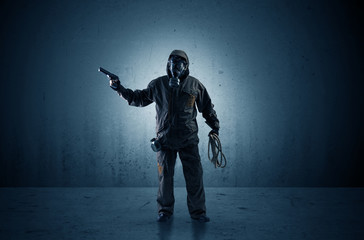 Bad agent in a dark room with arms on his hand and gas mask
