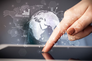 Hand using tablet with multinational worldwide estate report concept
