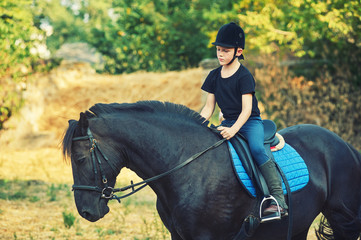 cheerful boy riding a horse, walking