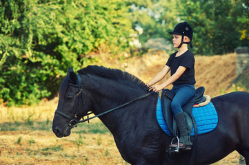 cheerful boy riding a horse, walking