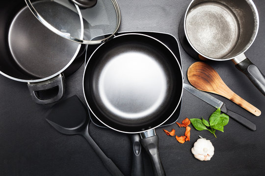 Top view frying pan and pot on black leather table image for cooking background and food design background.
