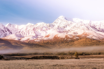 Mountain peak, snowy peak Sunny day. Landscape on the mountain range in pastel colors, autumn weather.
