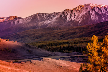 Beautiful view of the mountain range with snow-capped peaks. Landscape of mountain valleys and cliffs.