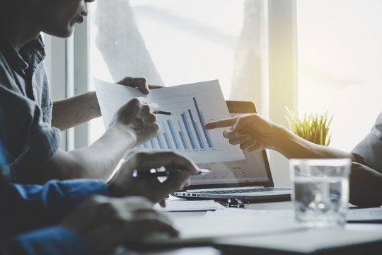 businessman meeting, analyzing and presenting finance on notebook, teamwork and coorperation concept