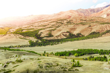 Fototapeta premium Colorful gentle hills in the cloudy sky.
