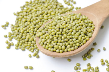raw green bean on wooden spoon in white background