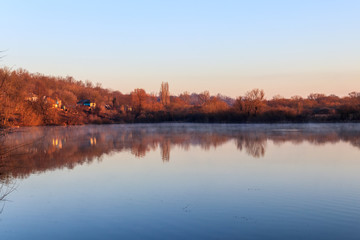 View on the peaceful lake and village at morning