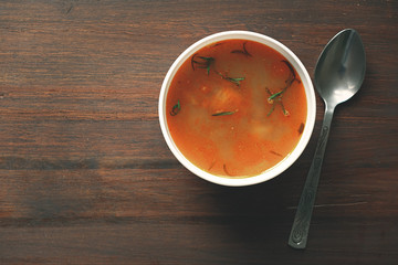 top view bowl with soup on wood table with spoon
