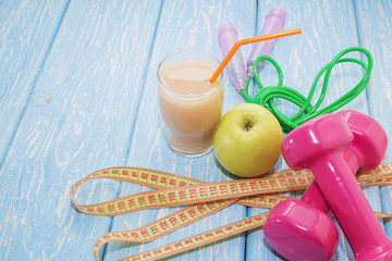 The concept of a healthy diet. Small dumbbells, juice. Bananas. Oranges. Apples. healthy lifestyle. sport. Fitness food.