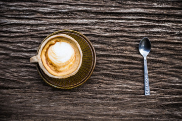 Hot latte art coffee texture on wood table