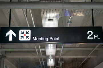 Meeting point information board sign at international airport terminal