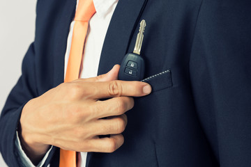 Businessman holding the  car key, isolated background