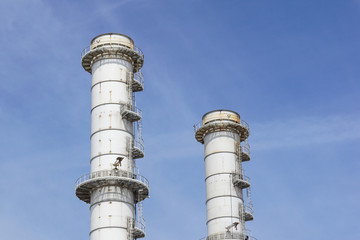 Pipes of industrial factory and blue sky background