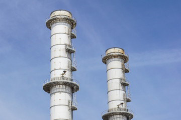 Pipes of industrial factory and blue sky background