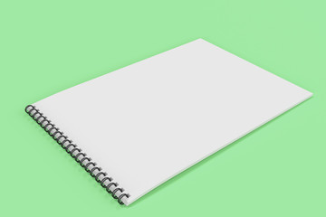 Blank white notebook with black spiral bound on green background