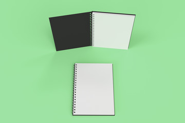 Two notebooks with spiral bound on green background