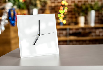 White clock on modern shelf. Mirror frame or interior room decoration.