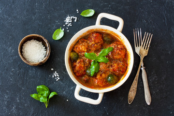 Meatballs and brussel sprouts stewed in tomato sauce