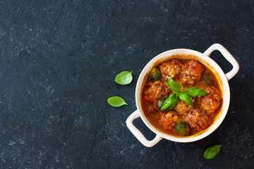 Meatballs and brussel sprouts stewed in tomato sauce