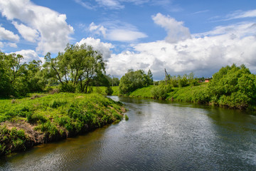 Landscape with a river and white clouds