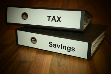 Two folders with labeling of tax and savings