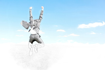 Businessman jumping in air against blue sky